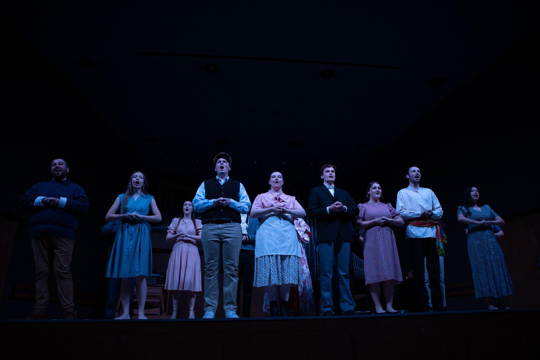 Music students singing together at a performance.